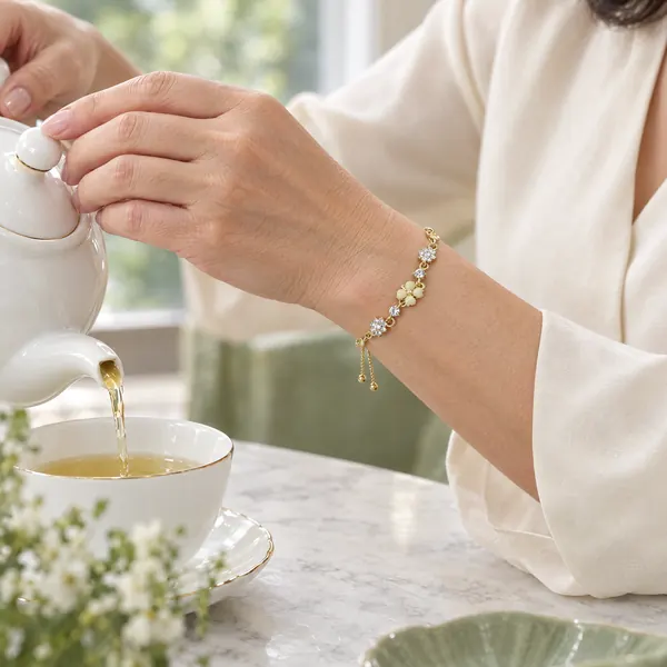 Close-up of a woman's wrist wearing the Golden Petal Serenade Bracelet